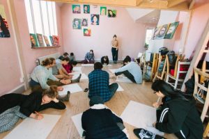 People sitting on the floor, drawing